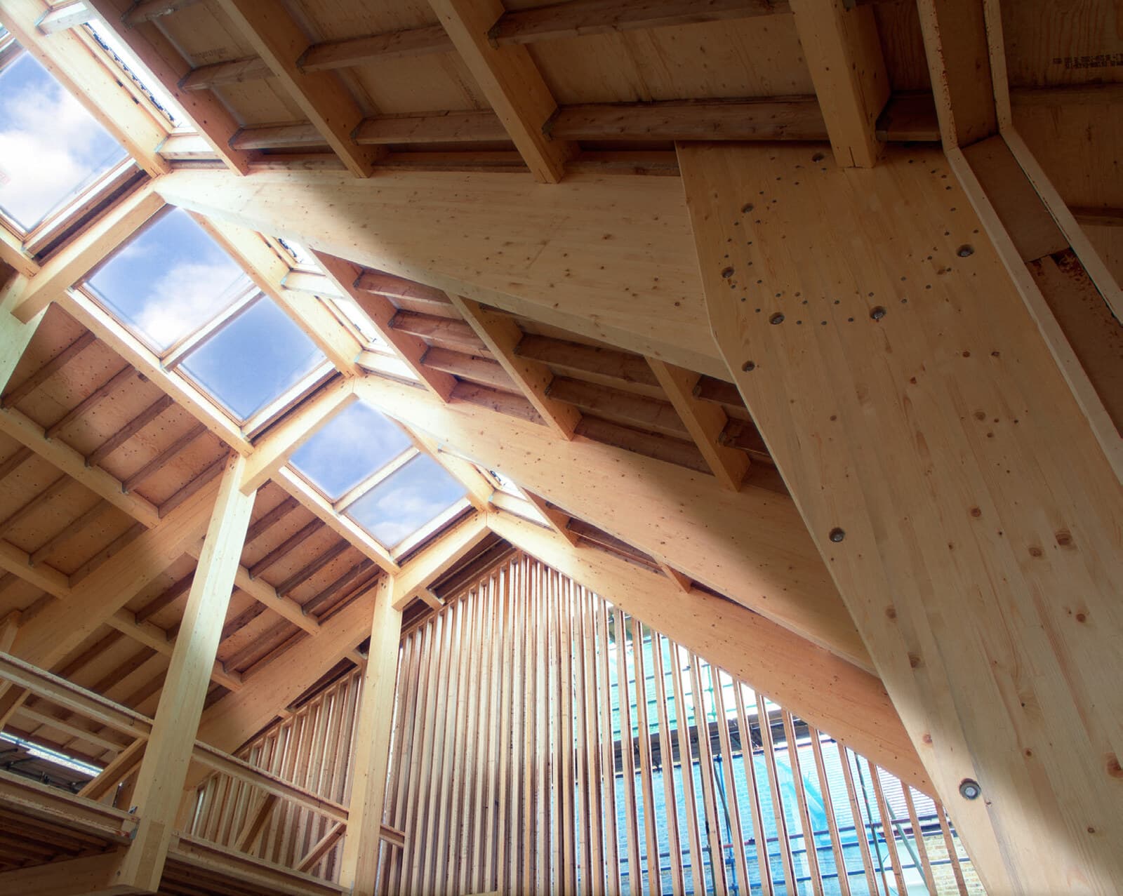 Sunlight through the skylights of a newly framed timber sanctuary roof