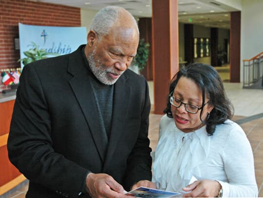 ABEC President and CEO Valoria L. Cheek reviewing project materials with Rev. Dr. Clifford A. Jones